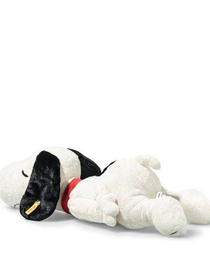Plush toy resembling a dog with a black nose and red collar on a white background