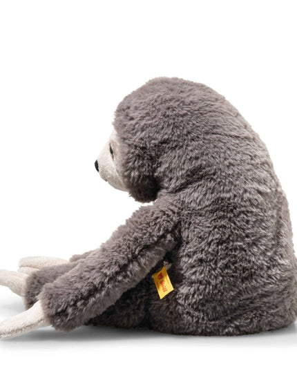 Plush sloth toy with a yellow tag on a white background
