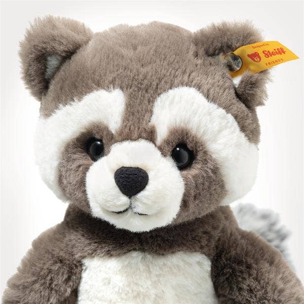 Plush raccoon toy with a visible Steiff tag on a white background