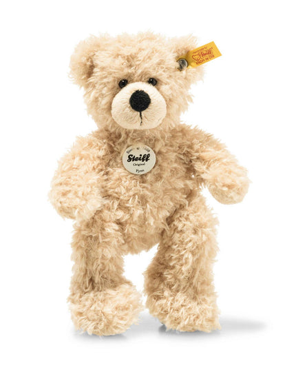 Plush teddy bear with a visible Steiff tag on a white background