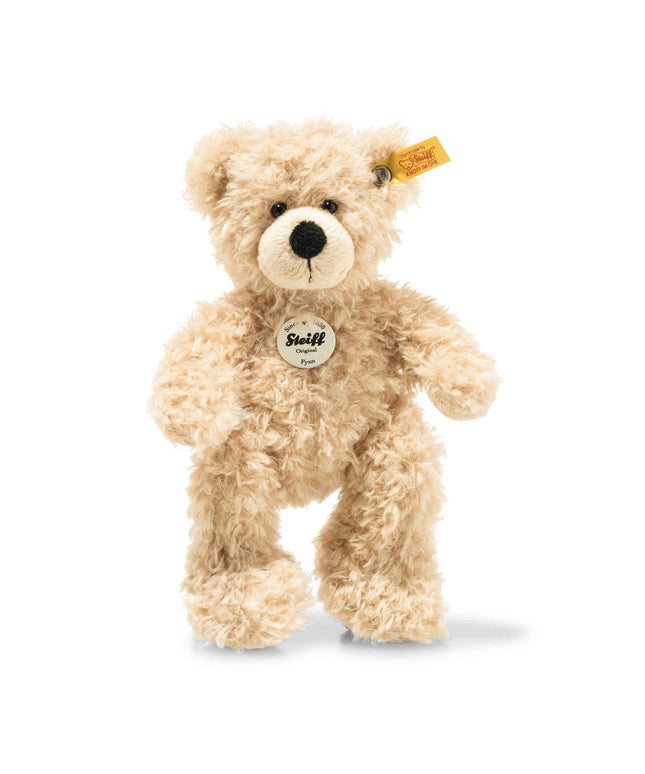 Plush teddy bear with a visible Steiff tag on a white background