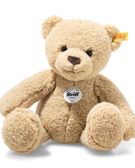 Beige teddy bear with a visible Steiff tag on a white background