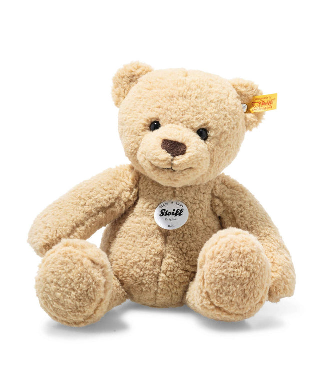 Beige teddy bear with a visible Steiff tag on a white background