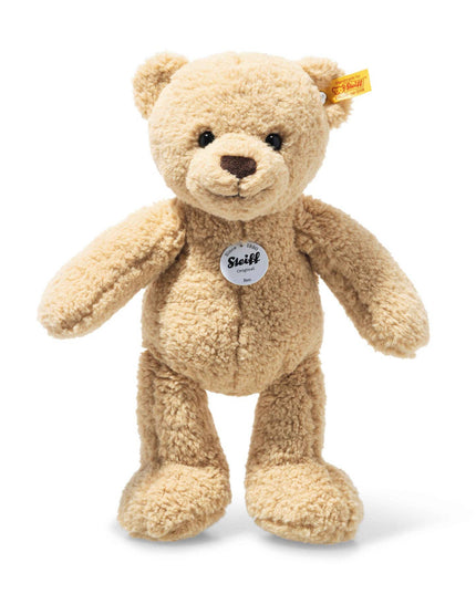Beige teddy bear with a visible brand tag on a white background