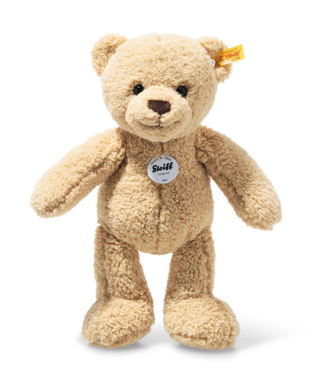 Beige teddy bear with a visible brand tag on a white background