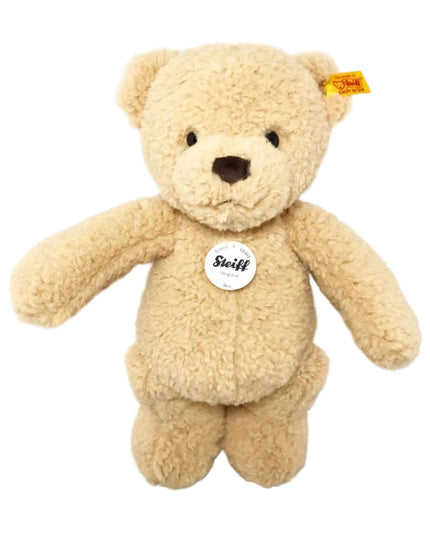 Beige teddy bear with a visible brand tag on a white background