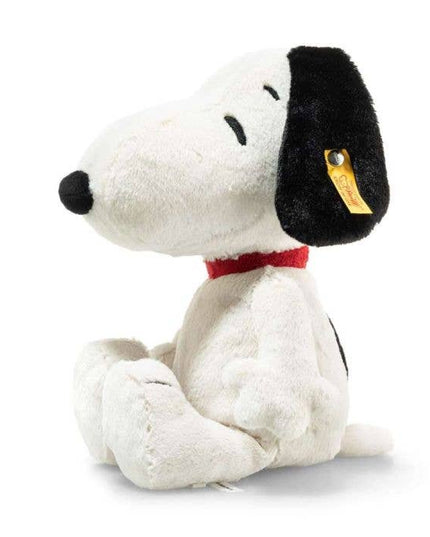 Plush toy Snoopy dog with a black nose and red collar on a white background
