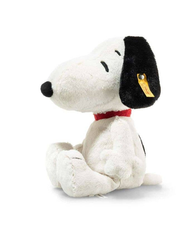 Plush toy Snoopy dog with a black nose and red collar on a white background