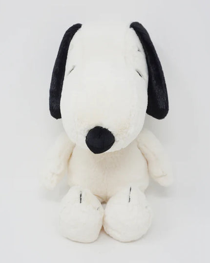 Plush toy resembling a dog with black ears and nose on a white background