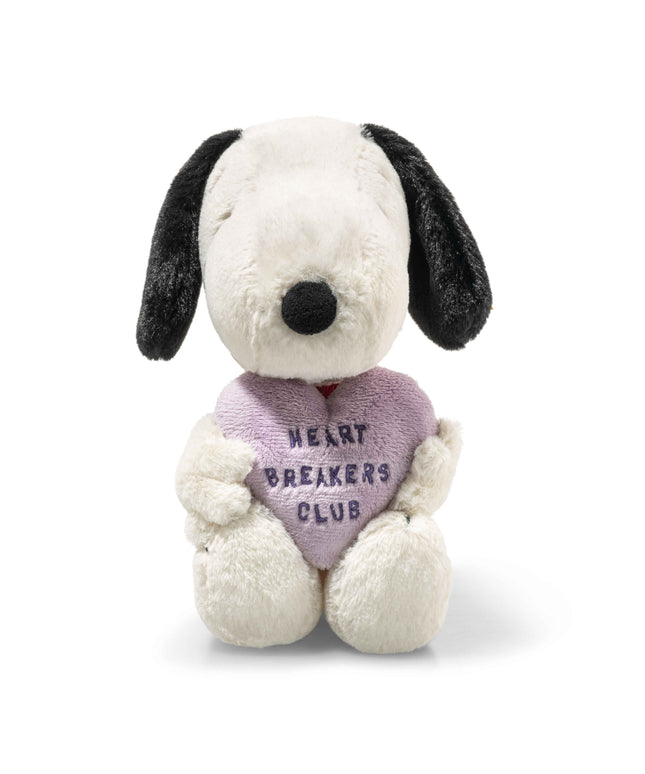 Stuffed dog toy with a heart-shaped 'Heart Breakers Club' pillow on a white background