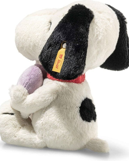 Plush dog toy with a purple heart and a visible brand tag on a white background