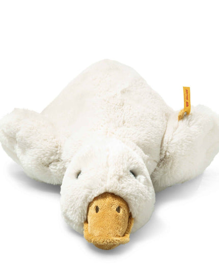 Plush toy goose lying on a white background