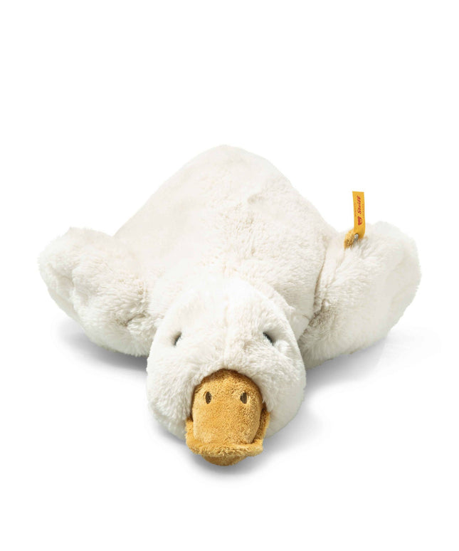 Plush toy goose lying on a white background