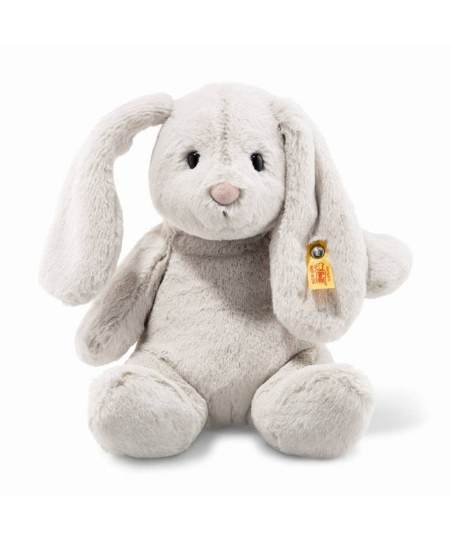 Plush rabbit toy with a visible brand tag on a white background