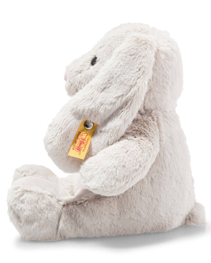 Plush bunny toy with a visible brand tag on a white background