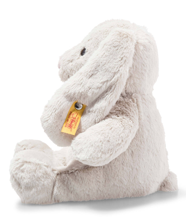 Plush bunny toy with a visible brand tag on a white background