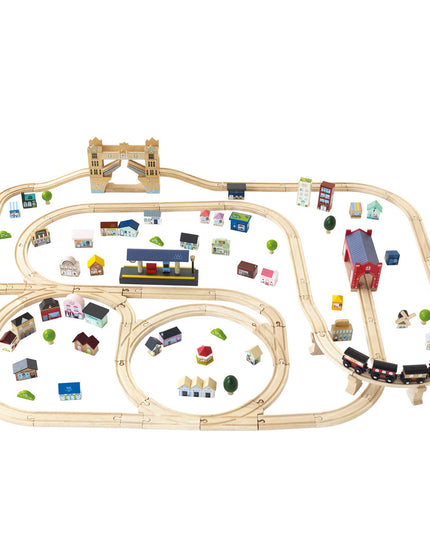 Wooden toy train set with tracks and small buildings on a white background