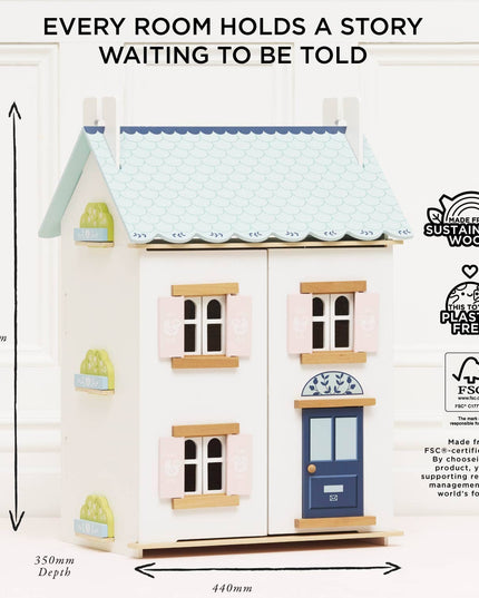 Wooden dollhouse with dimensions and sustainability certifications on a white background