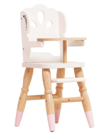 Wooden high chair with pink-dipped legs on a light pink background