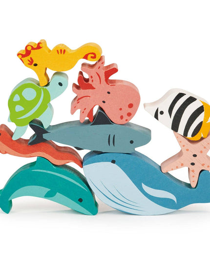 Colorful wooden sea creature toys stacked on a white background