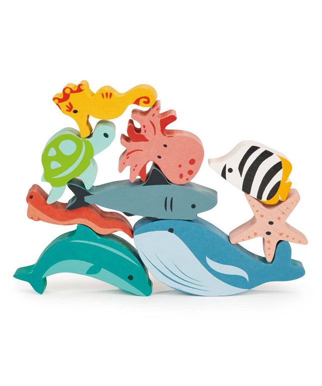 Colorful wooden sea creature toys stacked on a white background