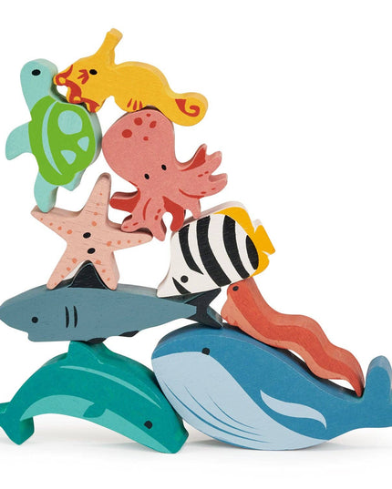 Colorful wooden sea creature toys on a white background