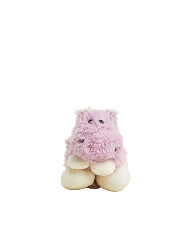 Pink plush toy with white feet on a beige background