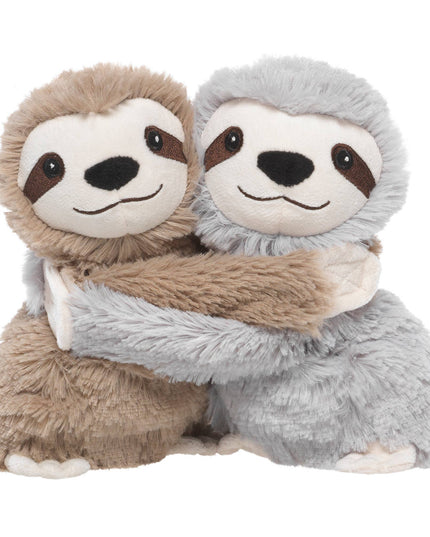 Two plush sloths hugging each other on a white background