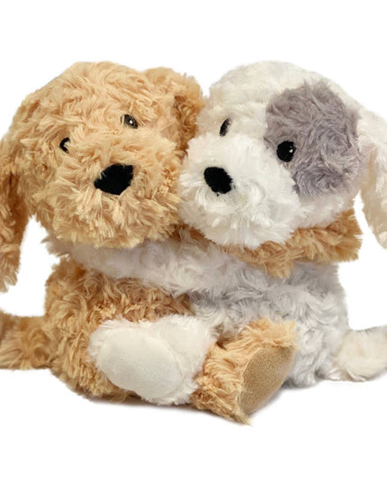 Two plush dogs, one brown and one white with gray patches, on a white background.
