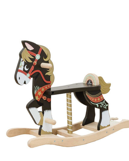 Wooden rocking horse with decorative elements on a wooden floor.