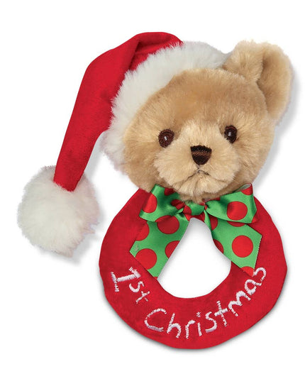 Teddy bear wearing a red Santa hat and wreath with '1st Christmas' text on a white background