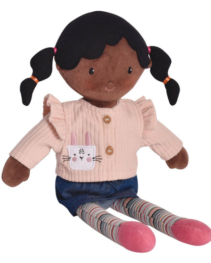 Stuffed doll with black hair in pigtails wearing a pink sweater with a bunny design, blue skirt, and striped socks on a white background.