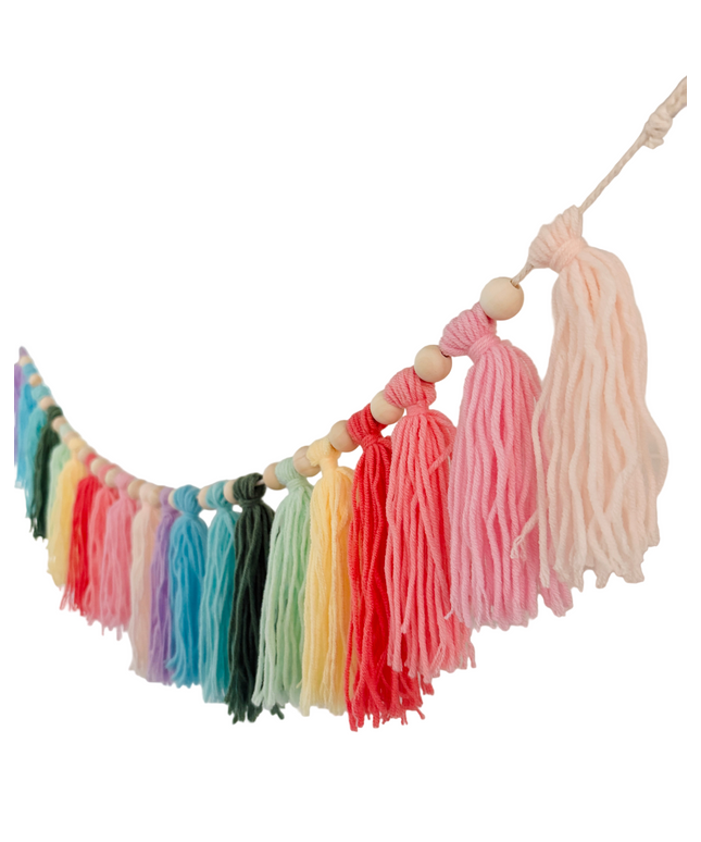 Colorful tassel garland hanging on a white wall
