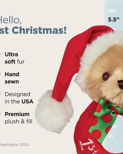 Teddy bear with a Santa hat and '1st Christmas' outfit on a light gray background