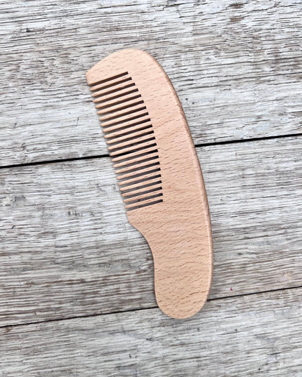 Wooden comb on a wooden surface