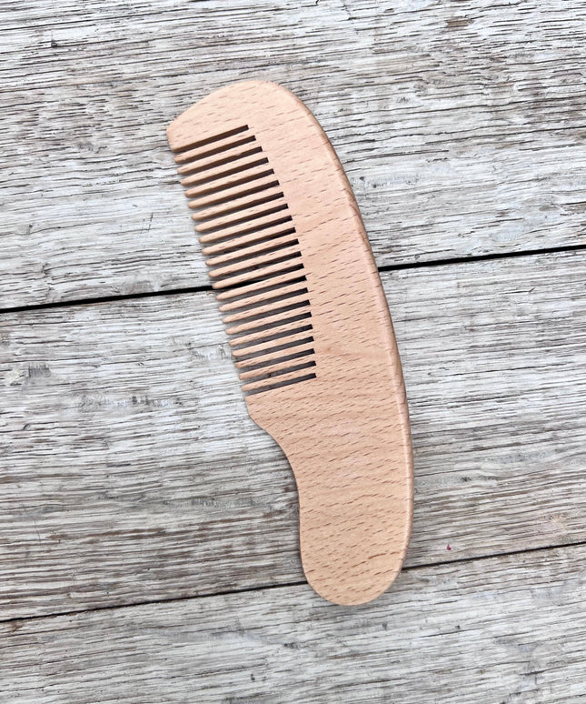 Wooden comb on a wooden surface